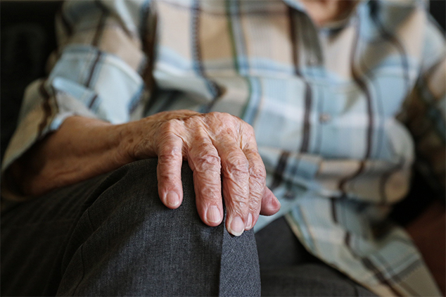 male resident sat with his hand on his knee
